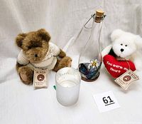 Photo showing both Boyd Bears with tags, a battery operated candle, and a butterfly bottle light.