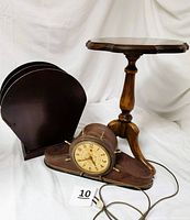 Lot showing all three items: Telechron clock, Federal style table, and mahogany magazine rack