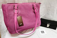 Dark pink crochet handbag with leather-like bottom and handles, showing front and side details