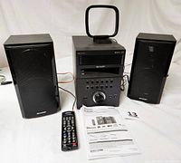 Full view of the Sharp XL-BH250 micro component system showing main unit, two speakers, remote control, AM loop antenna, FM antenna, and operation manual.