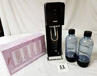 SodaStream system with 2 bottles and boxed set of 4 glasses.