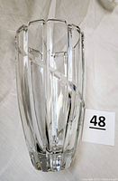 Front view of the clear glass vase showing the vertical cut ribs and swirl design, illustrating the thickness and clarity of the glass.