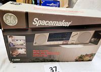 Front of the original box showing GE Spacemaker branding, product image, and model number 7-4250.