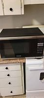 Front view of Panasonic microwave oven on kitchen counter.