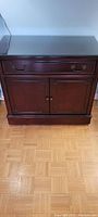 Front view of the mahogany finish sideboard showing drawer and cabinet doors.