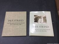 Two hardcover Paul Strand art books, one with linen slipcase the other with a torn dust jacket