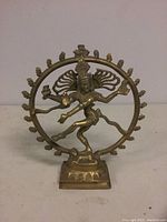Front view of brass Nataraja figure showing detailed arms, face, and base with circular flame design.
