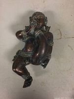 Full view of the bronze Bal Gopal Krishna sculpture showing the entire figure posed playing a flute.