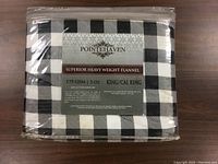 Photo showing original packaging with Pointehaven label detailing 175 GSM heavy weight flannel cotton king/California king duvet set.
