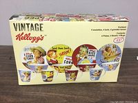 Original packaging box showing vintage Kellogg's advertising illustrations and list of contents: 4 plates, 4 bowls, 4 mugs.