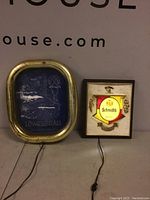 Photo showing both Lowenbrau and Schmidt's light up beer signs side by side with cords visible.