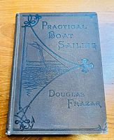 Front cover of the 1879 Practical Boat Sailing book showing title, author, and embossed sailing boat and anchor design.