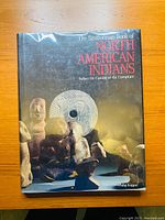 Front cover of the hardcover book showing title, author, and image of Native American artifacts.