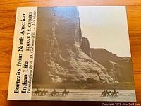 Front cover of the book showing title and author with an image of Native American riders against a rocky landscape.