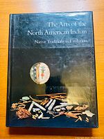 Front cover of the book showing title and Native American artifacts illustration.