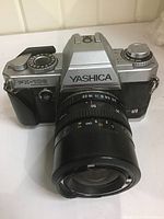 Front view showing Yashica FX-103 Program camera body with attached 50mm lens.