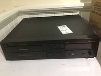 Front view of Nakamichi MB-2 MusicBank CD Player system showing loading slot and control buttons.