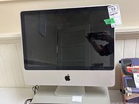 Front view of Apple iMac model A1224 desktop computer with screen off.