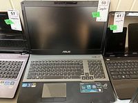 Front view of open laptop showing screen, keyboard and palm rest.