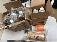 View of the lot with all bottles visible inside boxes and on the table.