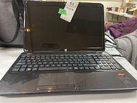 Front view of open black HP laptop showing screen and keyboard