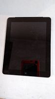 Front view of Apple iPad with black screen and home button.