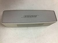 Top view showing Bose logo on silver metal grille of the compact speaker
