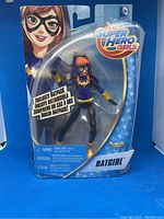 Photo of Batgirl action figure in original packaging showing figure and Batpack accessory.