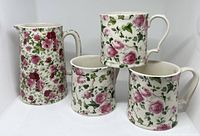 Photo showing the set of one floral pitcher and three matching mugs with rose print