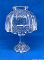 Clear glass fairy lamp fully assembled showing ribbed dome cover and fluted pedestal base