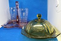 Yellow Depression glass round butter dish with embossed lid and knob handle with chip and flea bite visible