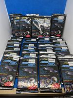 Thirty-six unopened packs of Star Trek The Next Generation Japanese trading cards from 1994 displayed upright and spread out.
