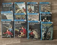 Front covers of 12 Hardy Boys books volumes 1-12, showing titles and cover art