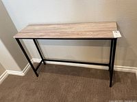 Full view of the console table showing the barnwood vinyl veneer top and metal frame legs.