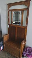 Full view of oak hall tree showing mirror, hooks, and bench