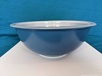 Side view showing glossy white opal glass and smooth rounded edges