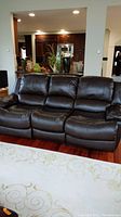 Full front view of three-seat electric leather recliner sofa in living space