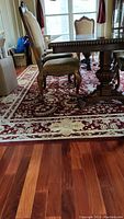 Full view of rug under dining table and chairs on hardwood floor