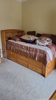 Full assembled bed showing six drawers and headboard shelving