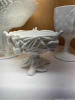 Small milk glass pedestal bowl with bow and berry pattern
