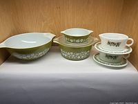 Full lot overview showing all items: large bowl, two casseroles (one with lid), and two gravy sets with plates.