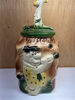 Front view of the ceramic Flintstones cookie jar showing Fred Flintstone figure and painted lettering.