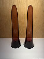 Front view of pair of tall purple amethyst glass candlestick holders.