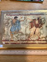 Full view of the fresco panel showing two Etruscan figures with some surface wear and dirt.