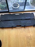Open view of the Plano Gun Guard hard gun case showing interior egg crate foam padding and handle.
