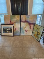 Four-piece wall art set including two abstract oil paintings, a framed photo print of a European scene, and a framed floral oil painting