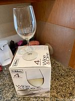 Single Libbey stemmed wine glass on box marked 4 Wine & Dine glasses