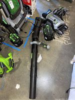 Full kit on ground showing blower housing, tube, battery and charger