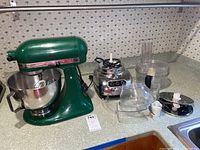 Green KitchenAid UltraPower stand mixer and food processor components on countertop