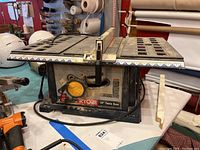 Front view of Ryobi table saw on tabletop showing overall unit and fence assembly